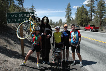 One arm the bike and the Onxy Summit sign